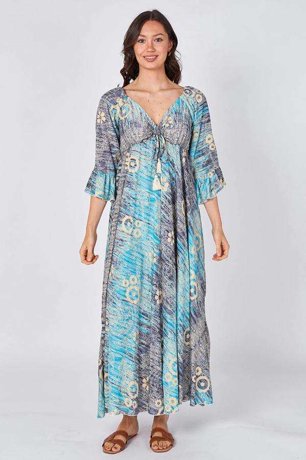 Woman wearing a blue patterned dress on a white background
