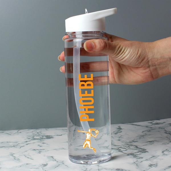 A person holding a clear 750ml sports water bottle custom-printed with the name 'Phoebe' and a vibrant orange graphic of a female basketball player jumping.