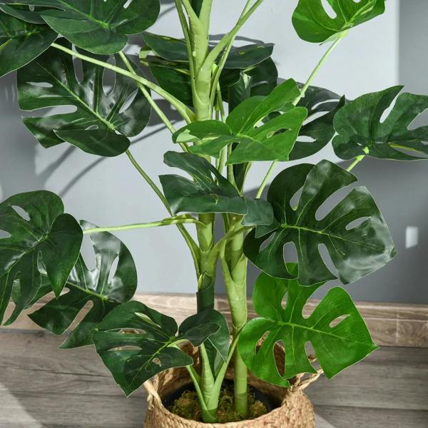 Close-up of artificial monstera stems and green split leaves