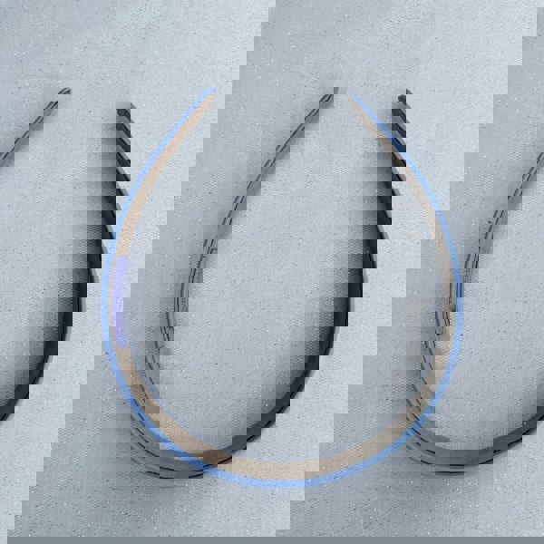 Light blue hairband, satin finish, smooth fabric texture, slim structured design, soft matte sheen, simple everyday accessory
