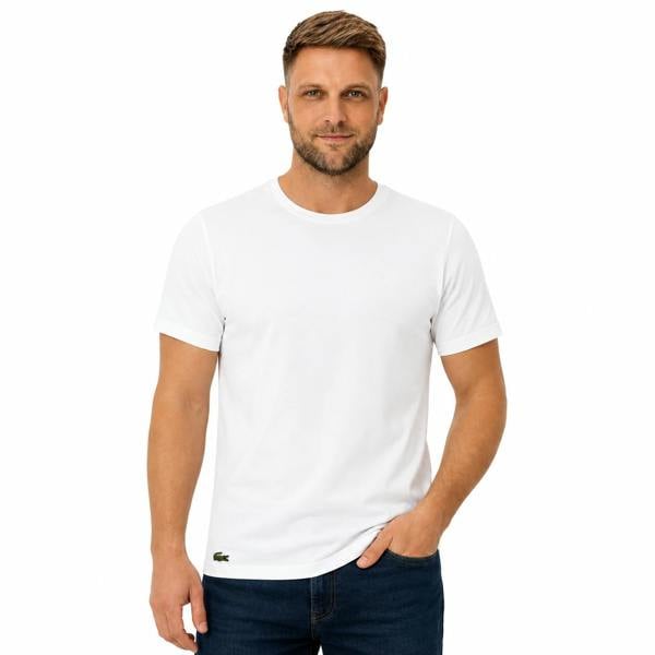 Man wearing a white Lacoste cotton lounge t-shirt with a small crocodile logo.