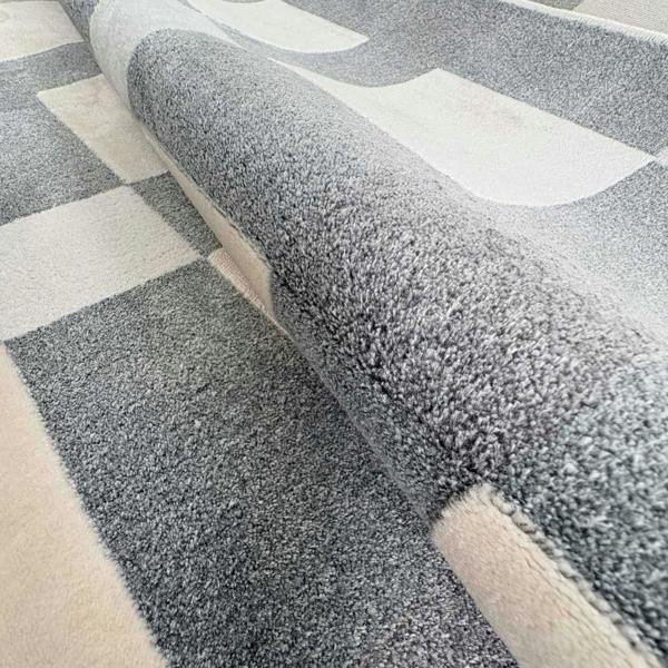 Gray and beige checkered patterned rug