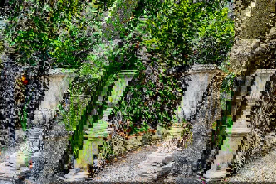 Pair of Large Stone Cast Flute Urns and Classic Plinths