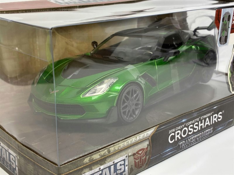 a green sports car in a box