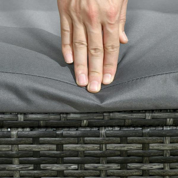 Close-up of grey cushion top with hand lifting seam edge on rattan lounger