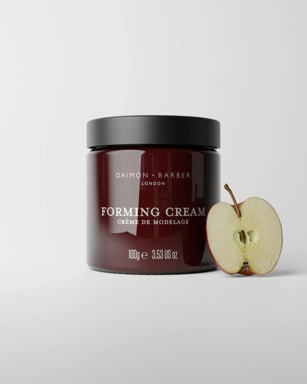 Jar of 100g Forming Cream with apple on grey background.