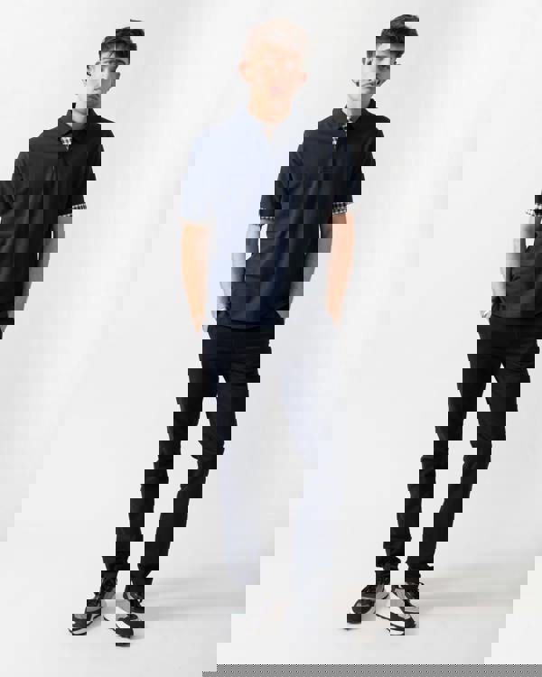 full length shot of a model wearing an Aquascutum Mens Club Check Stretch Piquet Sleeves Polo Shirt in Navy 11