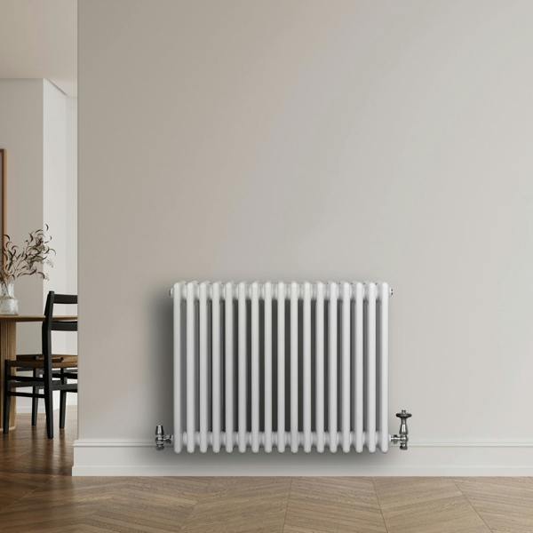 Traditional white 4 column radiator with a sleek design, featuring smooth, rounded edges and chrome valves, mounted on a light wall