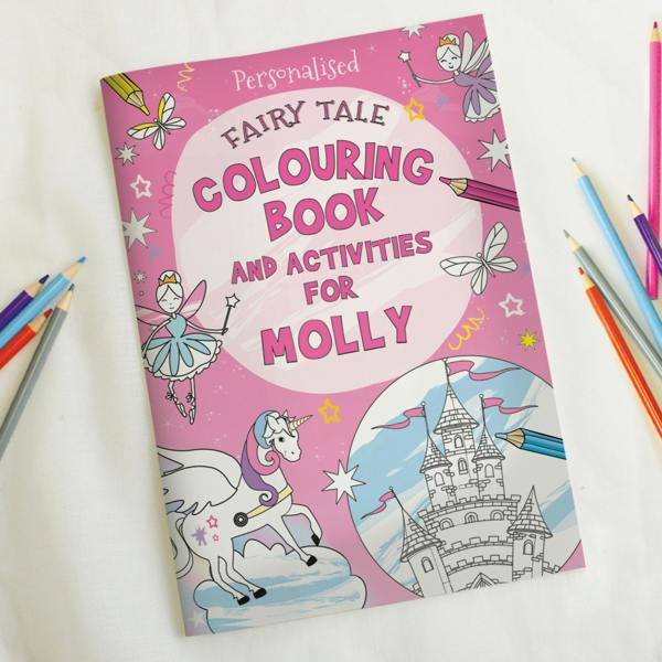Personalised pink fairy tale colouring book for Molly featuring a unicorn and castle illustration alongside colouring pencils