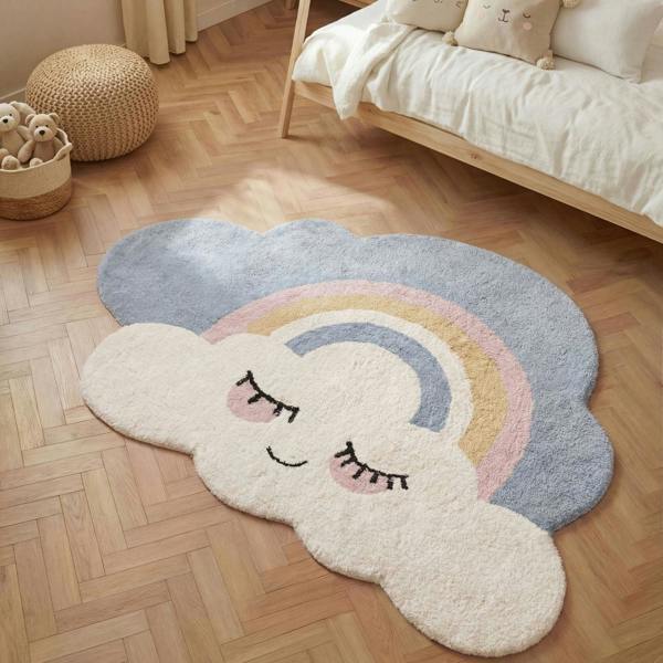 Cloud-shaped rug with a rainbow and smiley face on a wooden floor.