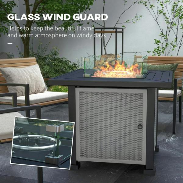 Grey gas fire pit table with clear glass wind guard and woven front panel