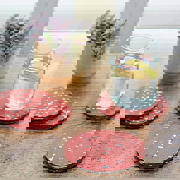 Set of 4 red polka dot coasters.