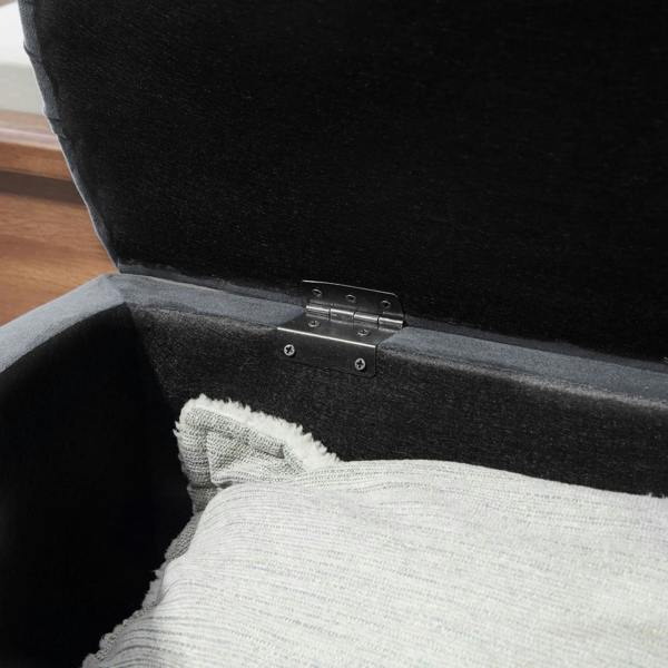 Dark grey storage ottoman open, showing metal hinge hardware and upholstered interior