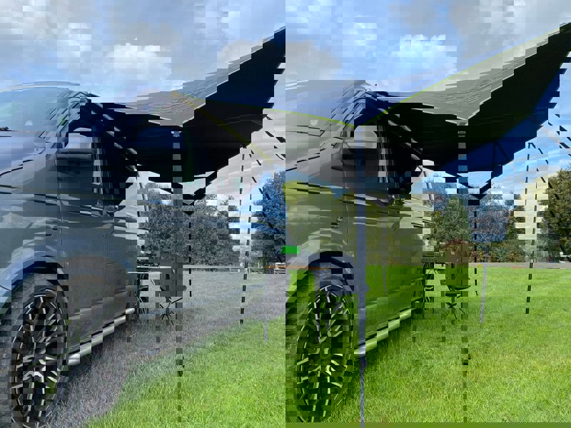 Image of Modern Shade Canopy grey with  Lime by OLPRO fitted on T5 Campervan, picture from left side showing the snug fir to the campervan.