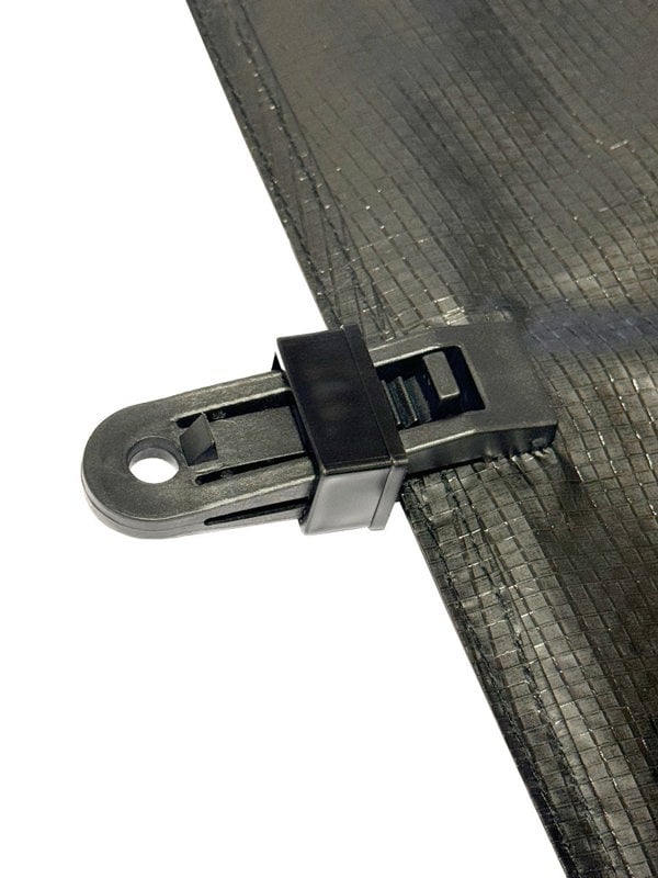 Illustration of a OLPRO Tent Groundsheet Pegging Clamp attached to a groundsheet, demonstrating one of its numerous applications. Available in a pack of four.