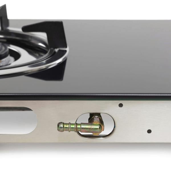 Close-up of a gas stove with a visible burner and gas outlet