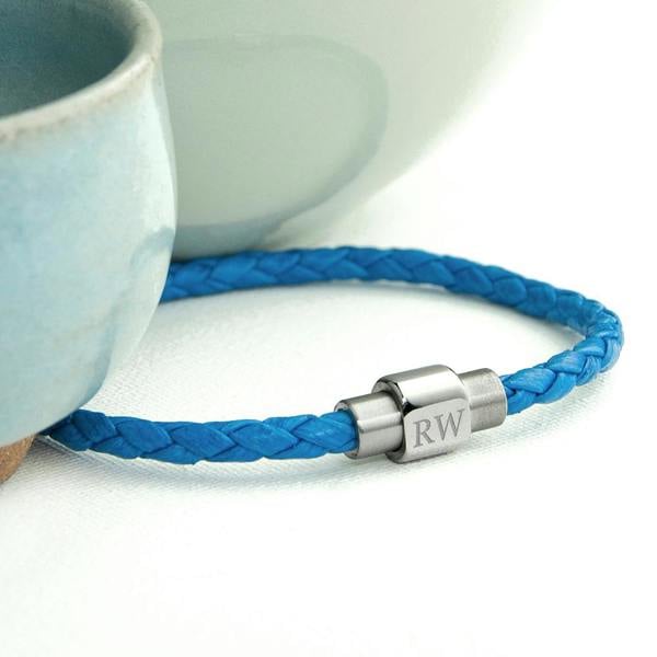 A vibrant cobalt blue woven leather men's bracelet with a silver metal magnetic clasp engraved with the initials RW.