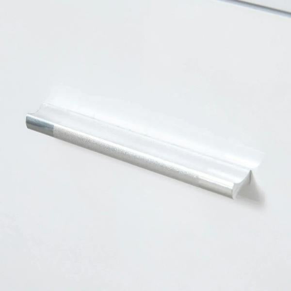 Silver metal bar handle on white high-gloss sideboard front panel