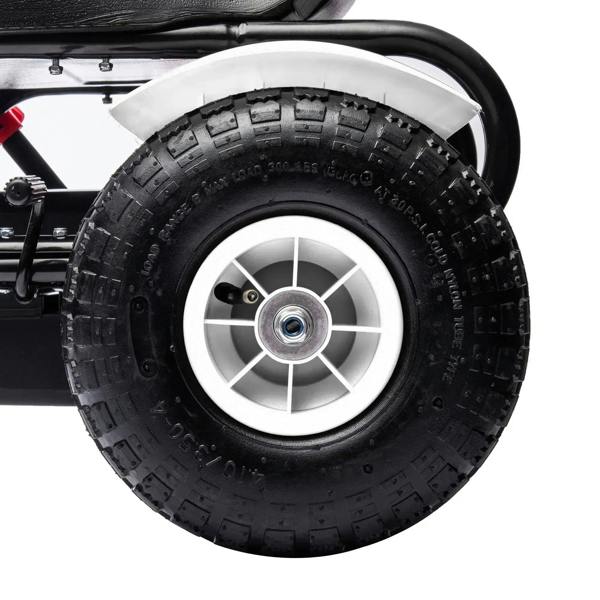 Close-up of a white kids pedal go-kart’s black tire with silver wheel rim