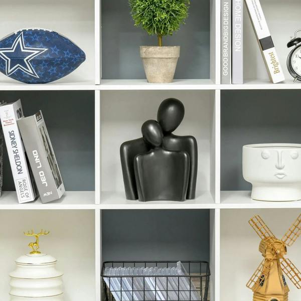 Close-up of white 9-cube storage unit with open compartments for books and decor