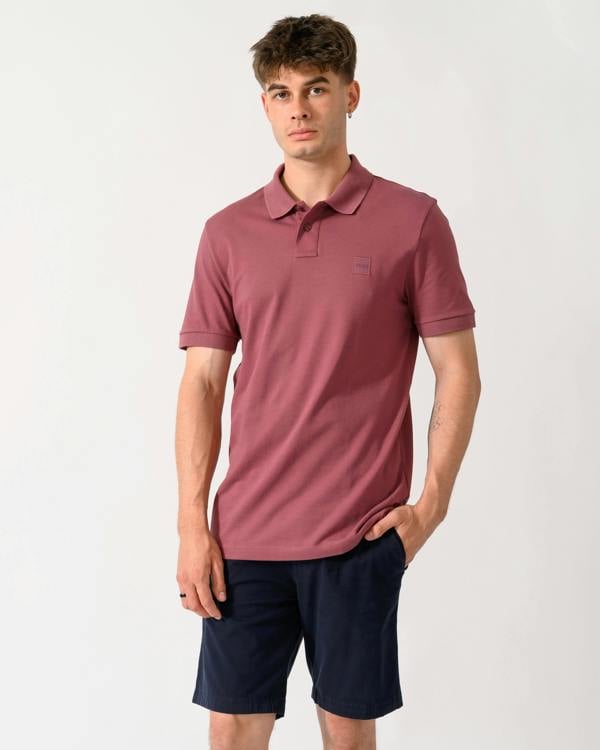 model wearing a BOSS Orange Passenger Mens Stretch-Cotton Slim-Fit Polo Shirt with Logo Patch in Medium Red 618