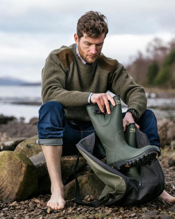 Man wearing hoggs of fife field sport neoprene wellingtons on a river bed