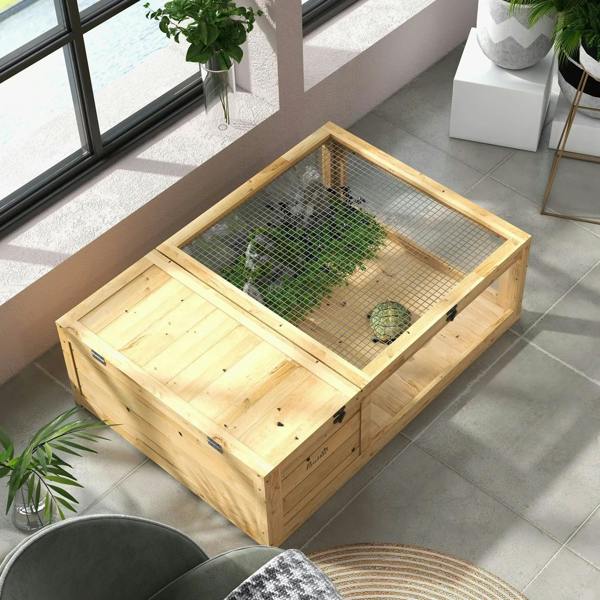 Small wooden reptile house with mesh top and side opening, placed indoors on tiles.