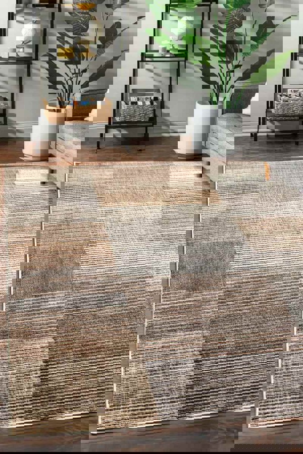 Aspre Shades Lines Rug in brown stripes, featuring a high-low texture, placed in a modern living room setting.