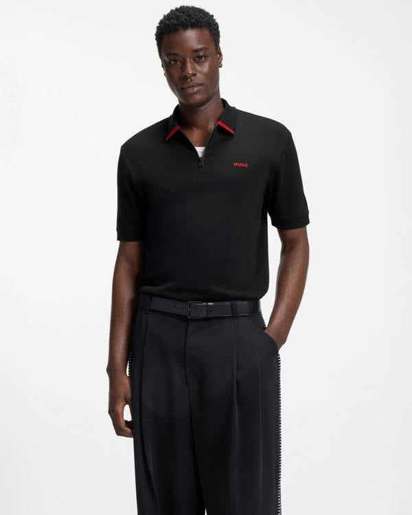 Model wearing HUGO Dalomino Mens Short Sleeve Zip Placket Polo Shirt with Contrast Logo in Black 002 - Front