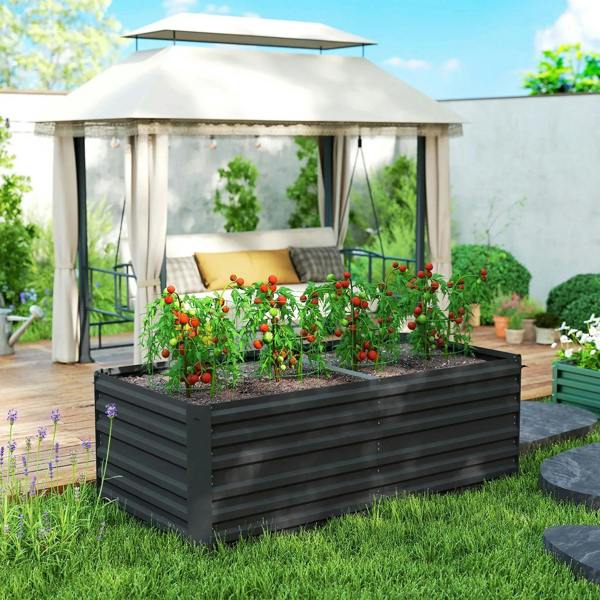 Black raised garden bed planter with dense fruit and flower plants in an outdoor shelter