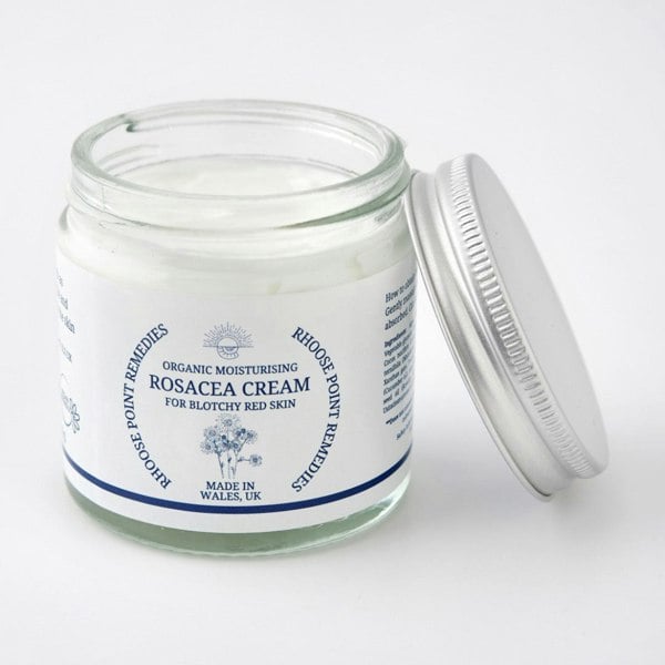 Glass jar of Rosacea Cream with a white lid on a light gray background