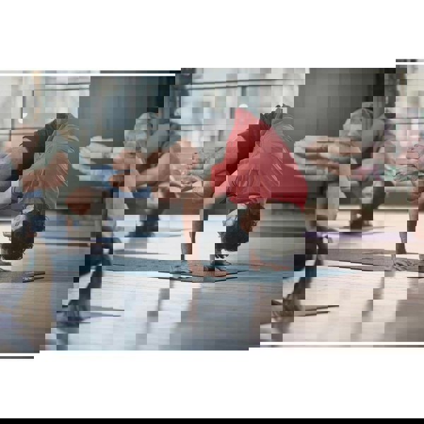 Yoga class doing a yoga pose on Reebok 4mm Yoga Mats