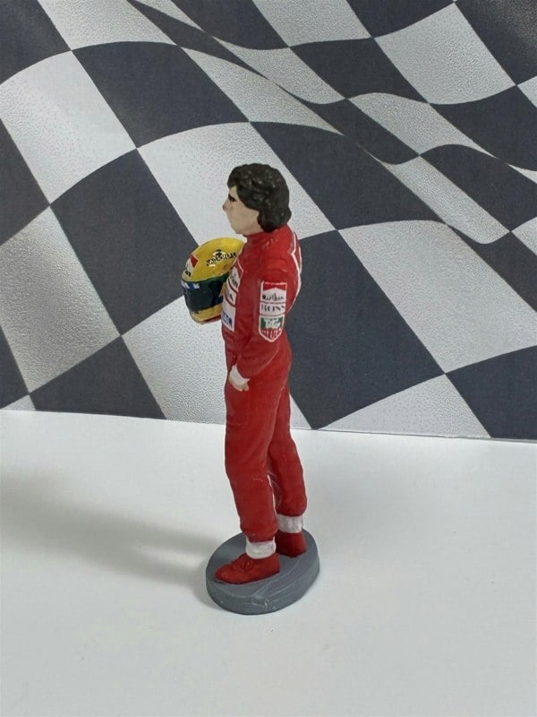 a toy figure of a man in red and white with a helmet