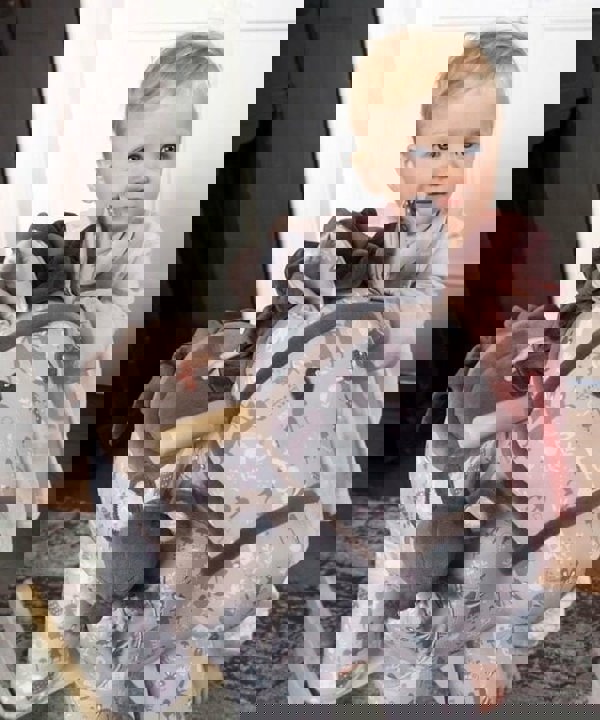 Little girl playing with Biscuit & Skip Rocking Horse with soft velour saddle, mane and tail