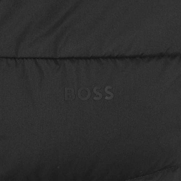Close-up of a black BOSS Urbanex puffer gilet featuring a tonal matte logo on quilted fabric.