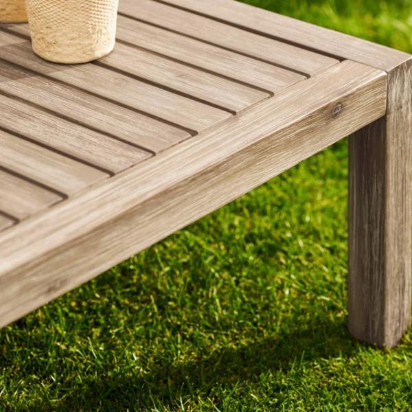 Close-up of the slatted whitewash acacia wood and weathered oak finish on a square coffee table.