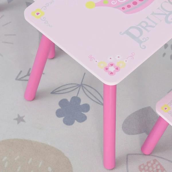 Close-up of pink-legged kids table with princess crown print on the white tabletop