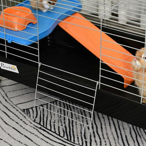 Orange ramp and blue platform inside black wire cage, with small animal near bars
