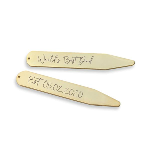 A pair of luxurious 18K gold-plated collar stiffeners resting on a crisp white dress shirt. The stiffeners are engraved with genuine handwriting; the top one reads "Forever & Always" and the bottom one reads "I Love You." Above the shirt, a white paper strip shows the original handwritten note.