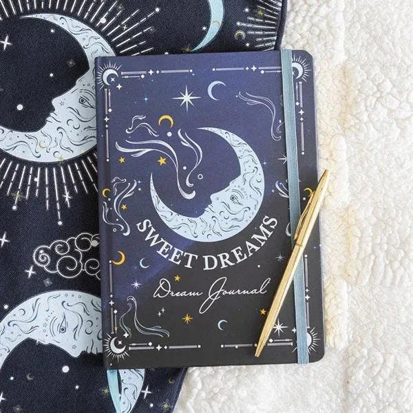 A5 dream journal with dark navy moon-and-stars cover, 'Sweet Dreams' text and gold pen