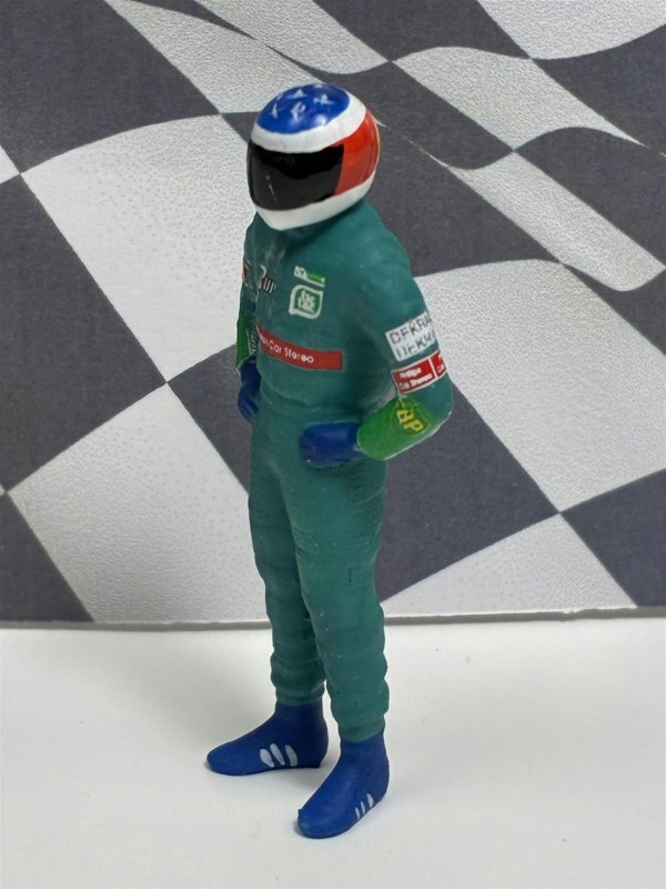 a toy figure of a race car driver