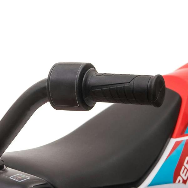 Black seat and handlebar grips on red and white kids electric motorcycle ride-on