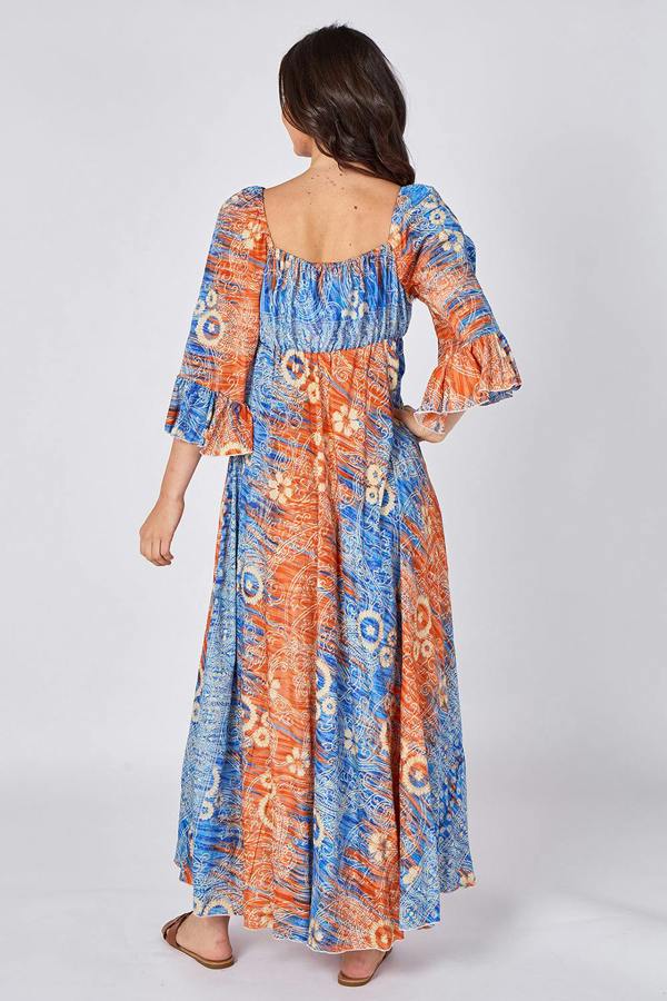 Woman wearing a colorful patterned dress on a white background