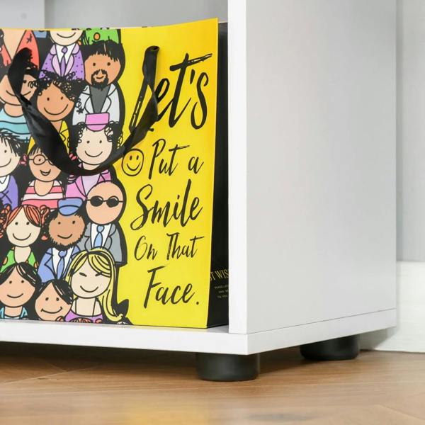 White 8-cube bookcase base corner with black protective foot pads on floor.