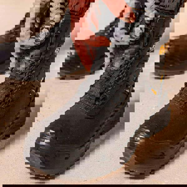 DeWalt Lander Boa Men's Safety Work Non-Metallic Safety Ankle Boots, close-up of a person adjusting the boot's BOA dial for secure fit.