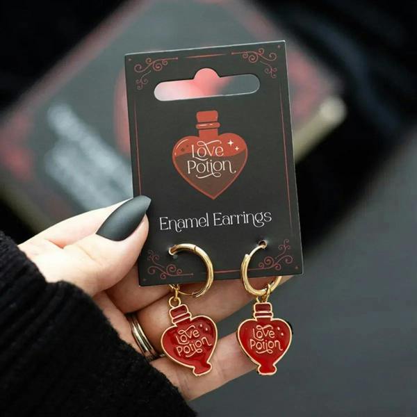 Red enamel heart potion dangle earrings with gold-tone hoops