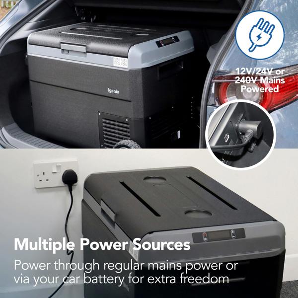 The Igenix 50L Portable Fridge Freezer, Black, is displayed in a car trunk and plugged into a wall socket, showing it works with 12V, 24V, or 240V power—ideal for camping with mains or car battery. Text reads: Multiple Power Sources.