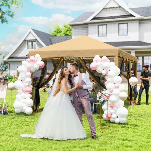 Beige wedding party gazebo with open sides, mesh curtains, and a couple under the canopy.