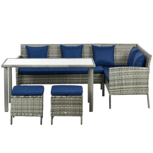 Rattan outdoor dining set with rectangular table, dark blue cushions, and storage ottomans