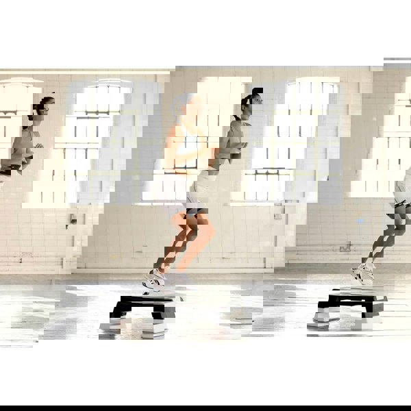 Woman performing a Reebok Step Home Workout - White